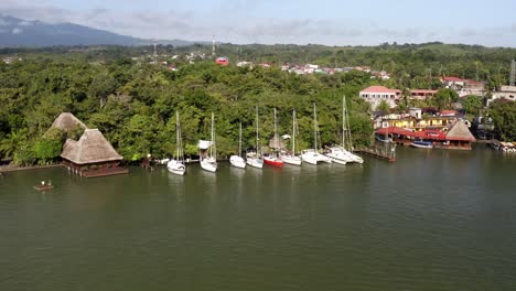 Aerial-Drone-Boat-Landscape-of-Dulce-River-Izabal-Guatemala-Wildlife-Village