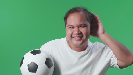 man listening attentively with soccer ball