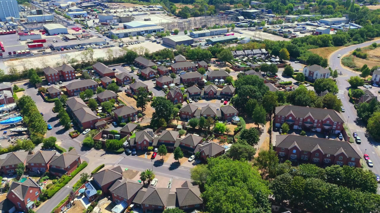 Marchwood is a Hampshire village on Southampton Water near the New Forest, featuring residential estates, local boatyards, and a major military port on sunny summers day with dry grass.