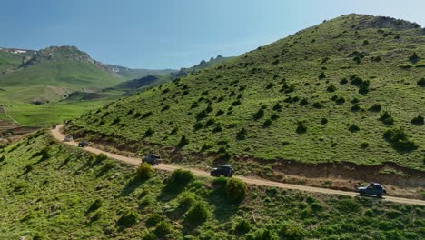off-road vehicles drive through scenic mountain landscape, adventure concept