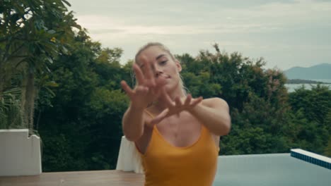 woman posing by a pool