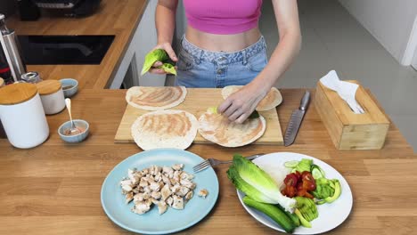 woman making chicken wraps