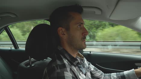 angry man driver shows middle finger, road rage, profile interior shot