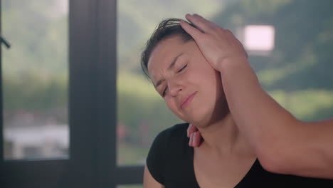 woman receiving neck and head massage for pain relief