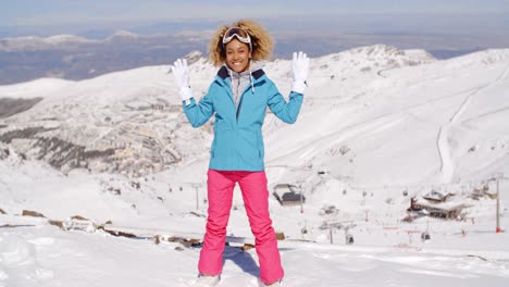 Single-woman-in-ski-clothes-waving-arms