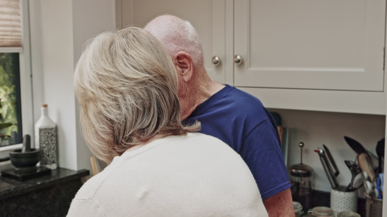 Elderly couple enjoying tea in their kitchen