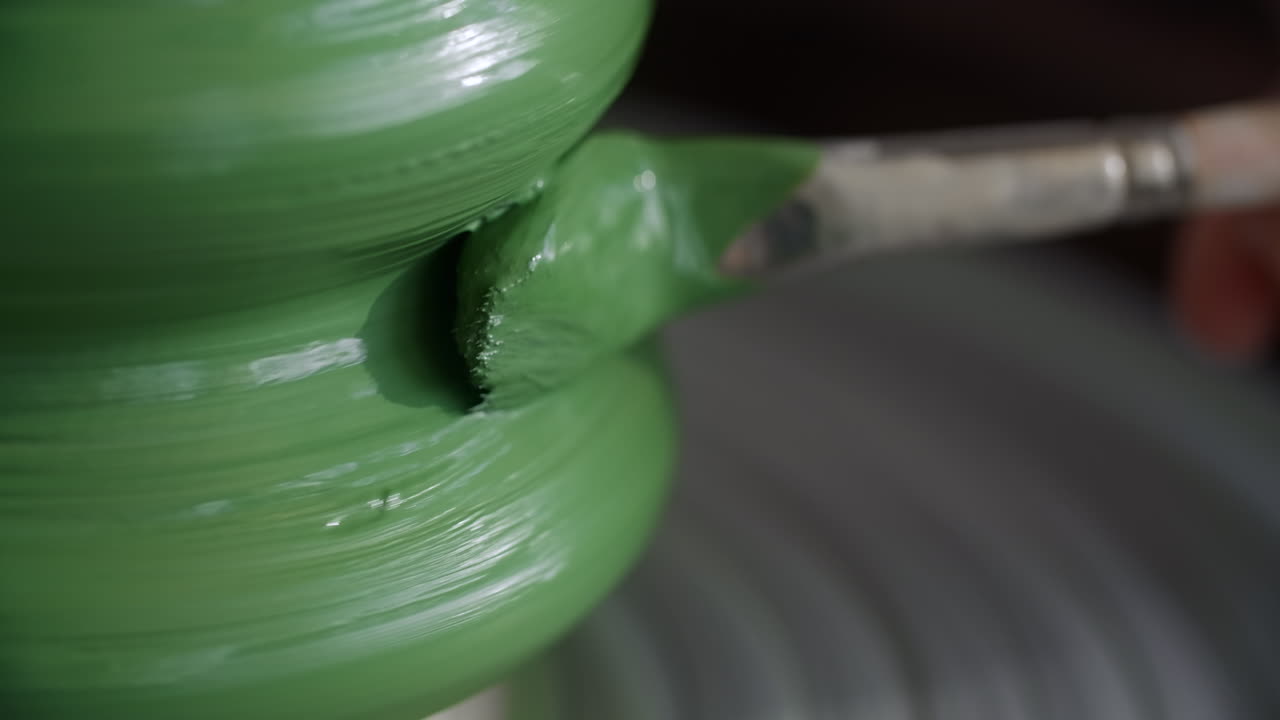 Painting a Green Ceramic Pot on a Pottery Wheel