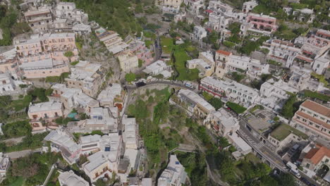 aerial footage over the town of positano showing the roads and houses on the hills above the sea