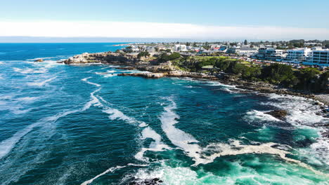 waves smash into rocky shore of scenic coastal town hermanus