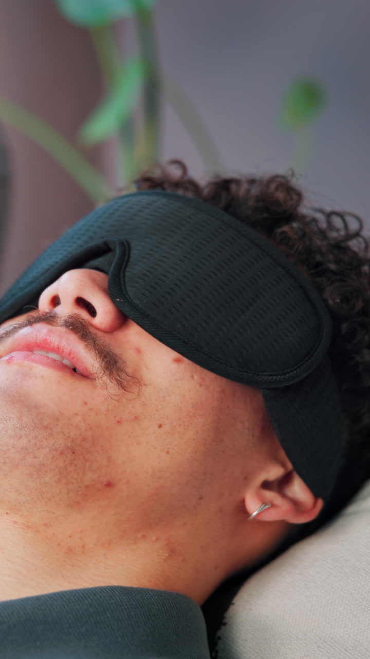 Close-Up of Young Man Sleeping Peacefully with a Black Eye Mask