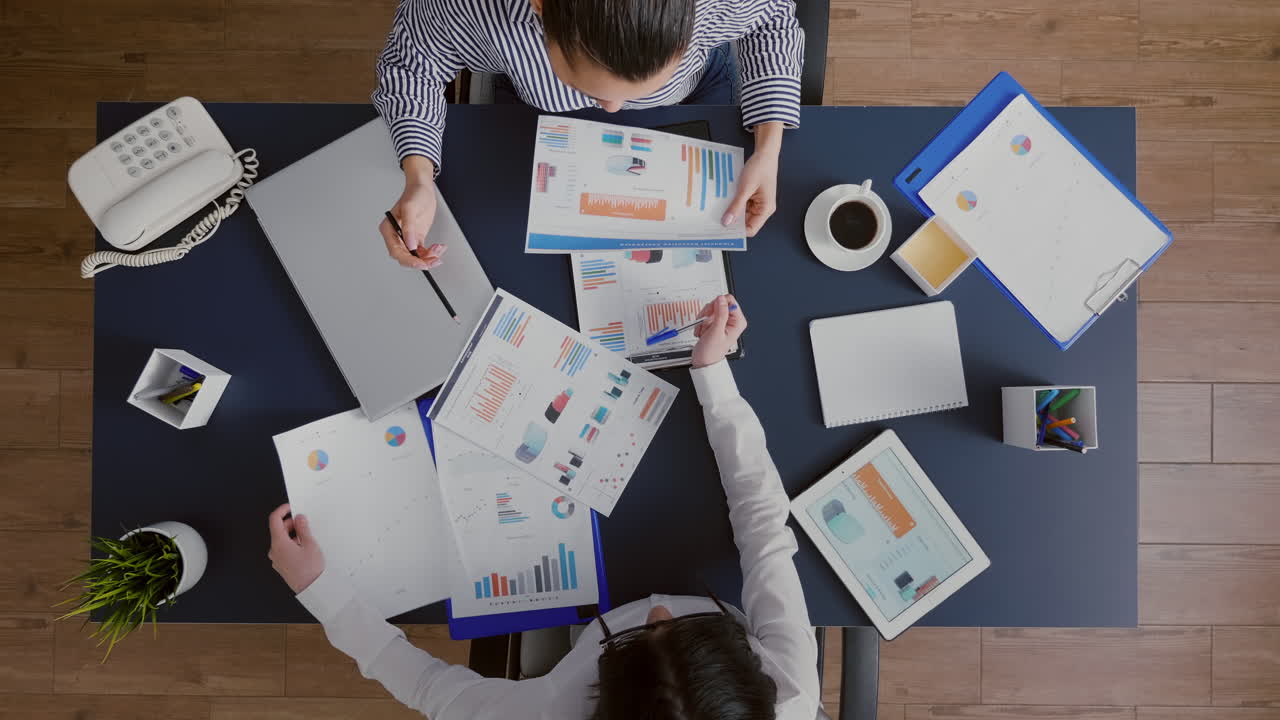 Top view of entrepreneurs woman checking management graphs paperwork