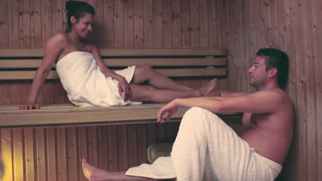 couple relaxing and talking together in a sauna