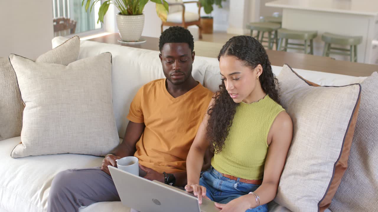Vertical video: Woman starting typing on laptop, couple working on tech task while man holding mug
