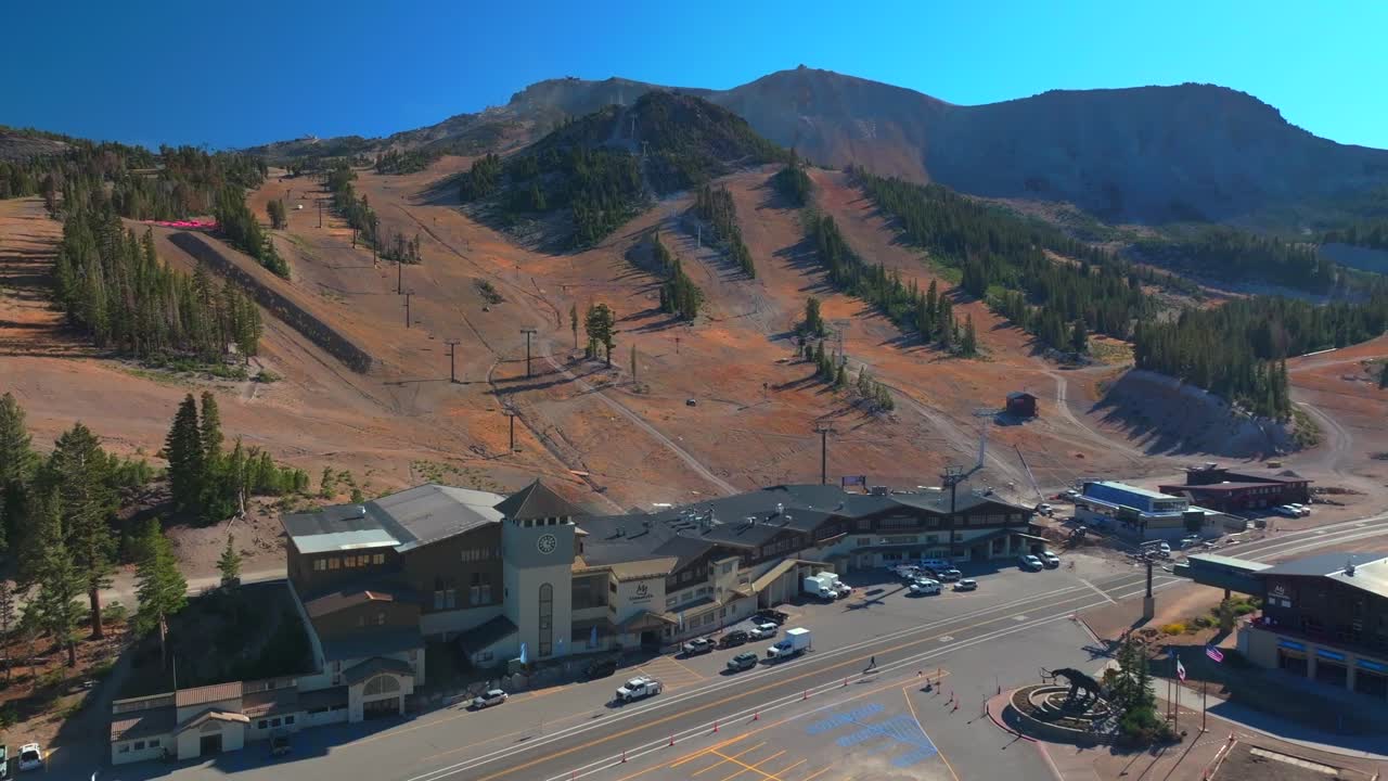Mammoth Lakes Mountain Ski Area McCoy Station Main lodge Minarets Upper Panorama Gondola summer autumn fall aerial drone California parking lot cars sunny daytime blue sky chairlift gondola upwards