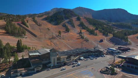 mammoth lakes mountain ski area mccoy station main lodge minarets upper panorama gondola summer autumn fall aerial drone california parking lot cars sunny daytime blue sky chairlift gondola upwards