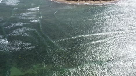 aerial dangerous square waves rolling in of a summer coastline