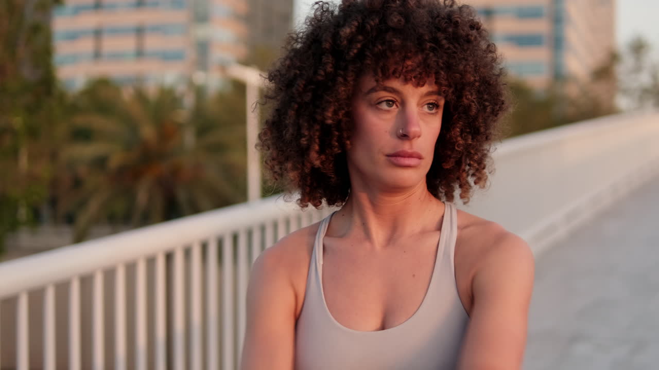 Young Woman Stretching on a City Bridge