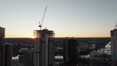 aerial shot of cranes in construction site building high-riser apartments and offices