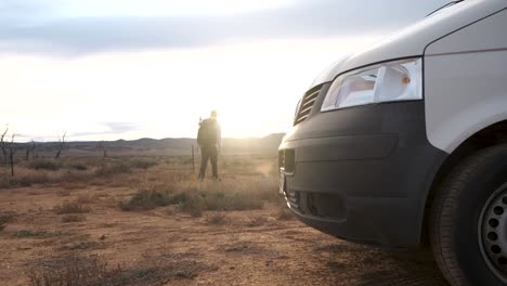 Photographer-with-backpack-walk-away-from-white-van-to-explore-Australian-Outback