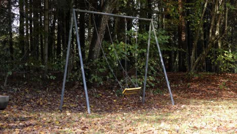 creepy scene of swing set moving with nobody on it