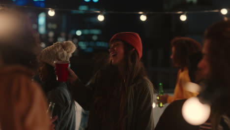 happy group of friends dancing to lively rooftop party music enjoying weekend celebration in urban city at night