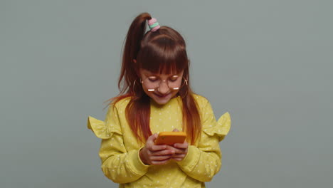 Child-girl-kid-use-mobile-smartphone-browsing-say-Wow-yes-found-out-great-win-good-news-celebrate