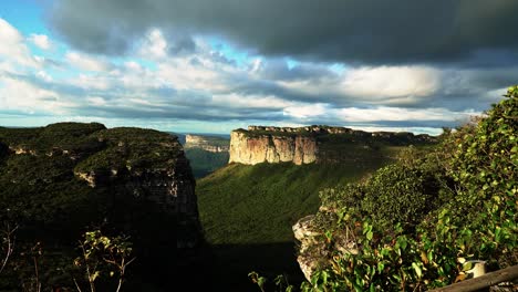 tilting up shot revealing the stunning capao valley with large plateaus from the mount of pai inácio hike in the chapada diamantina national park in northern brazil on a warm summer evening