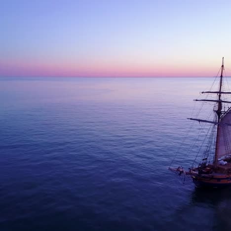 Spectacular-aerial-of-a-tall-sailing-ships-on-the-open-ocean-at-sunset-4