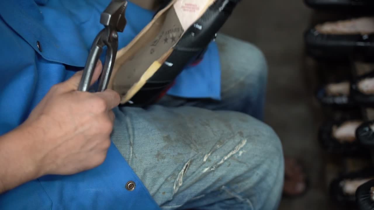 a craftsman handmade a shoe, close up shot, insert shot