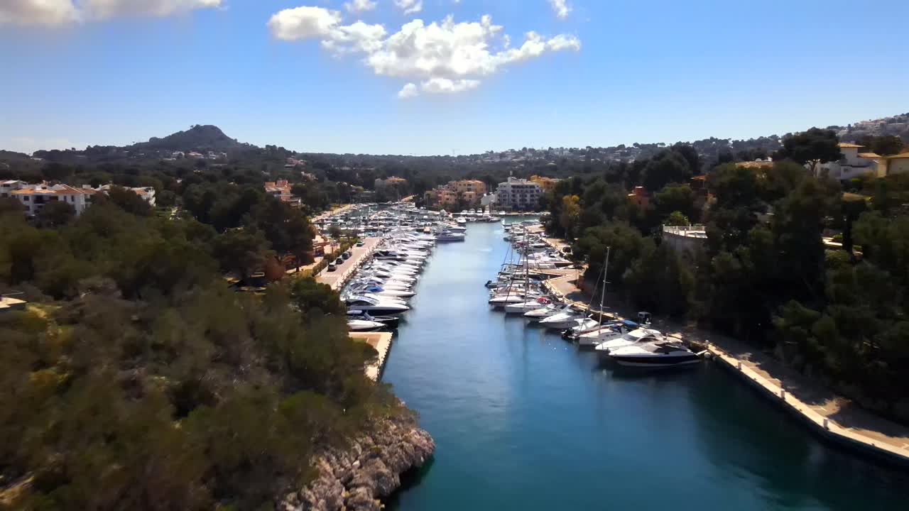 Enjoy breathtaking views of Santa Ponsa's picturesque harbor, lined with luxurious boats and lush greenery. The serene ambiance and coastal beauty make it an ideal destination for relaxation.