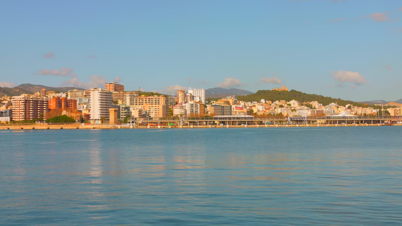 Profile view of a cityscape of Palma de Mallorca during sunset in Spain. Seafront. 4k.