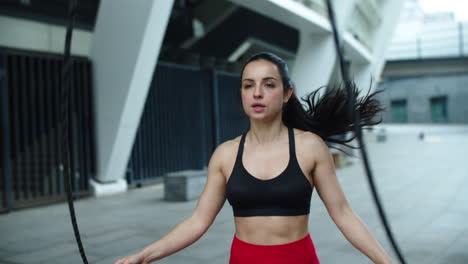 Athlete-woman-jumping-with-skipping-rope.-Sporty-woman-training-cardio-exercise