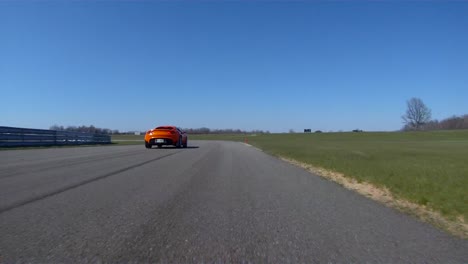 low angle view, race car competing and driving fast on race track lap, adrenaline