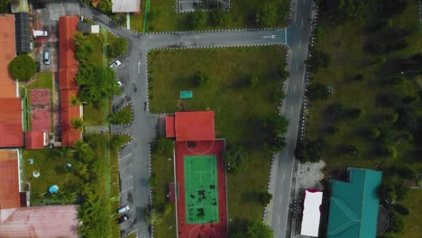 Cinematic-Drone-Footage-of-Palm-Oil-Mill-Effluent-residential-consists-of-buildings,-homes,-main-road-and-infrastructure-surrounded-by-palm-oil-trees-deforestation-located-in-Indonesia-in-full-HD