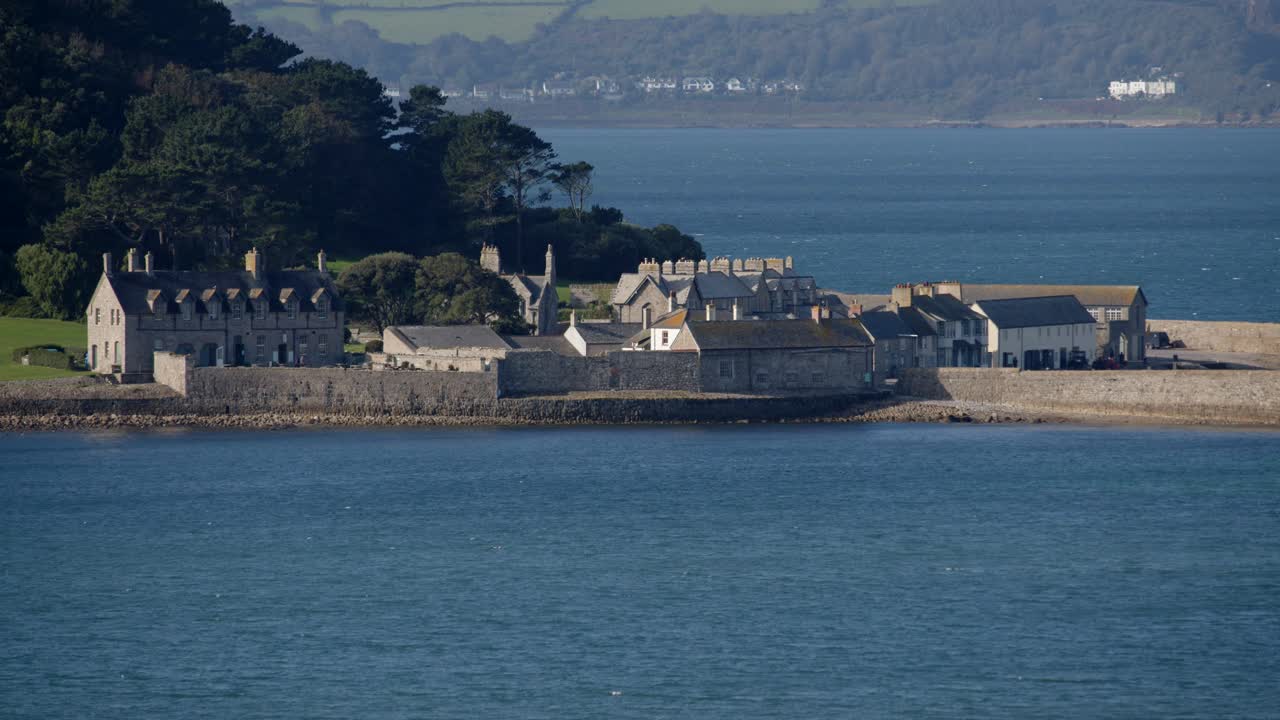 Mid shot of harbour buildings on St Michael's mount taken from the village of Marazion