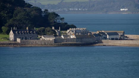 mid shot of harbour buildings on st michael's mount taken from the village of marazion