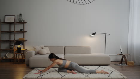 woman practicing yoga stretches at home