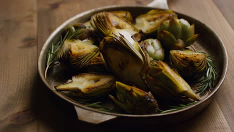 roasted artichokes with rosemary in a pan