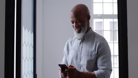 Businessman-using-mobile-phone-at-office-4k