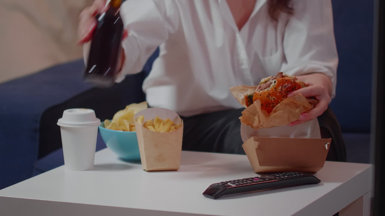 Close up of table with delivery fast food and person eating