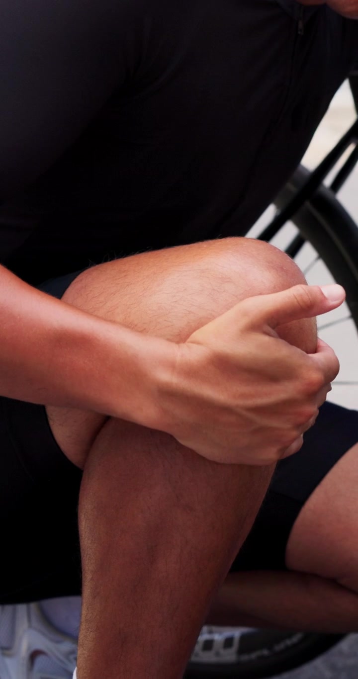 Cyclist Rubbing Sore Knee After Cycling Workout