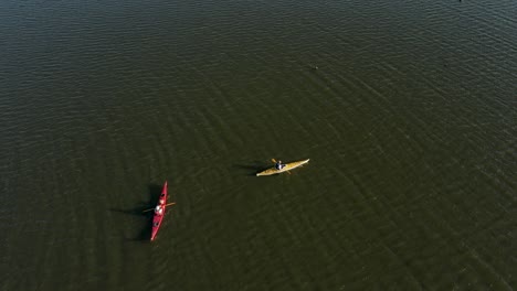 kayaks in calm water on the lake, aerial view