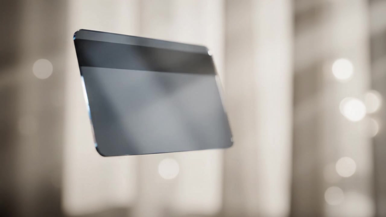Una elegante tarjeta de crédito deslizándose sin esfuerzo por el aire, capturando un momento de tecnología y diseño modernos contra un fondo suave e iluminado.