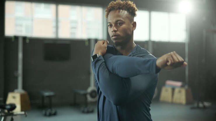 Man Stretching in Gym