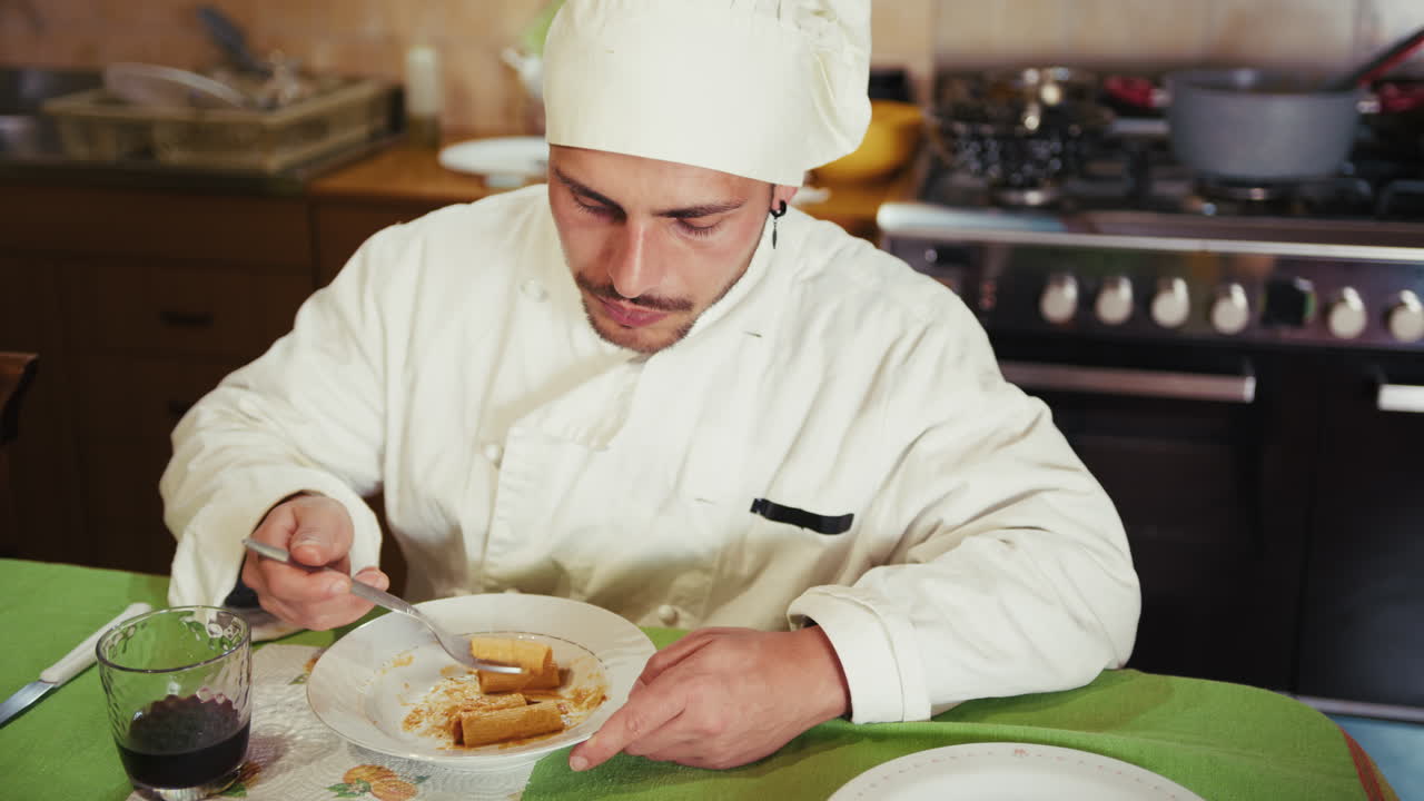 Chef Eating Pasta in a Kitchen