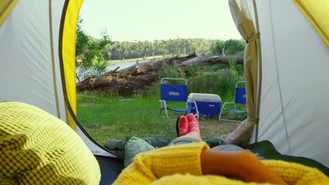 low section of woman relaxing in tent in the forest 4k