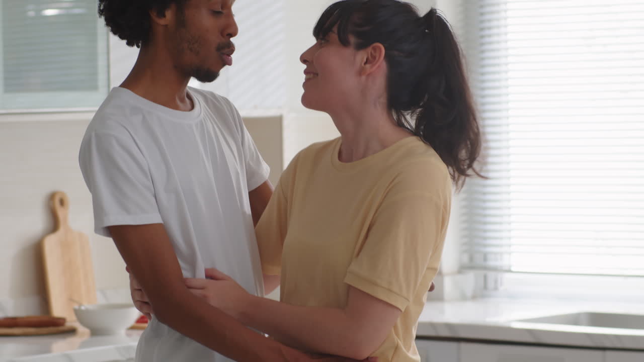 Portrait of Happy Biracial Couple Posing at Home Kitchen