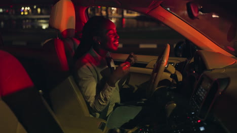 woman singing while driving at night