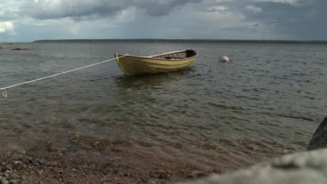 vessel in shallows of käsmu bay tied onto shore, bad weather approaching, baltic sea, estonia