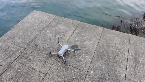 drone on a ground ready for take off, flying near water